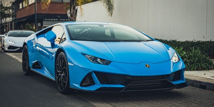 blue lamborghini aventador parked on gray asphalt road during daytime