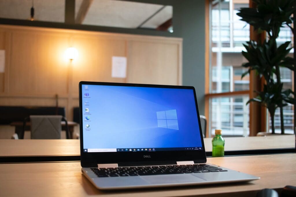 black and gray asus laptop computer on brown wooden table