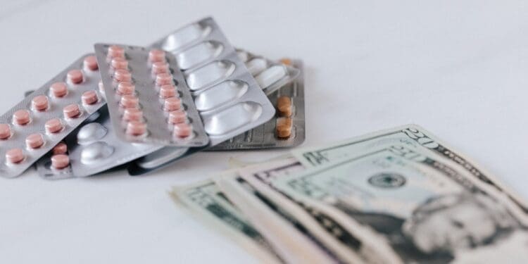 various pill packages near american dollar bills