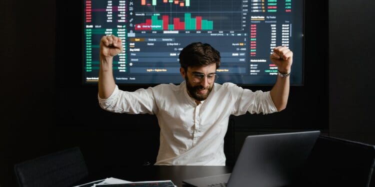 a businessman raising his hands for being successful