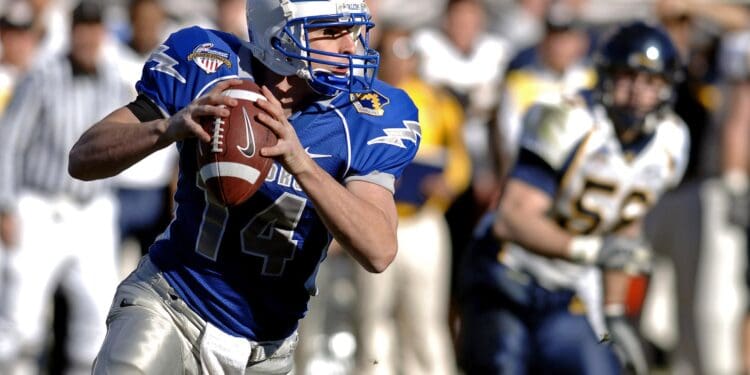 selective focus photography of man holding nike football ball