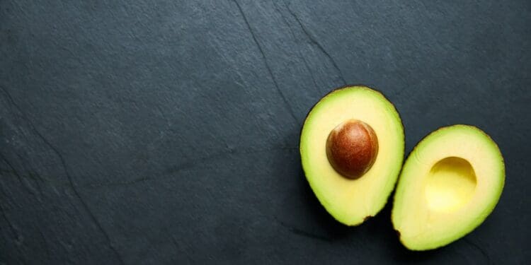 two green round fruits on gray textile
