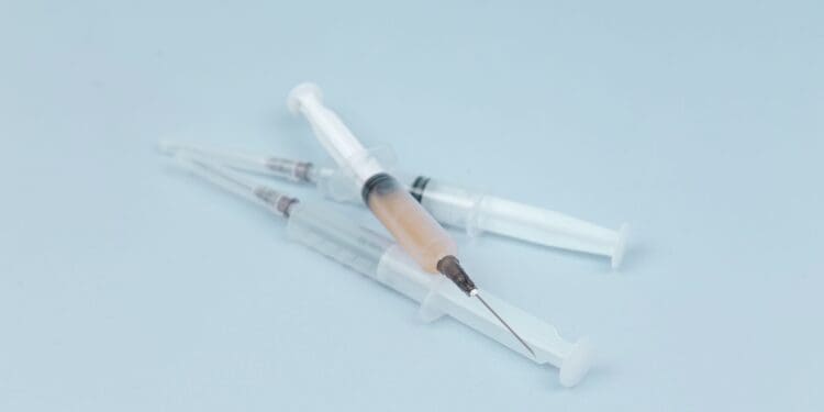 white and clear plastic syringe
