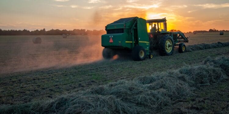 green farm heavy equipment on green field