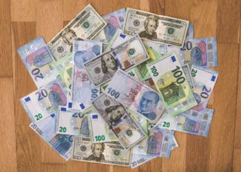 10 and 20 banknotes on brown wooden table