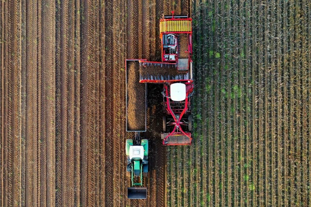 two red and gray trucks on brown field
