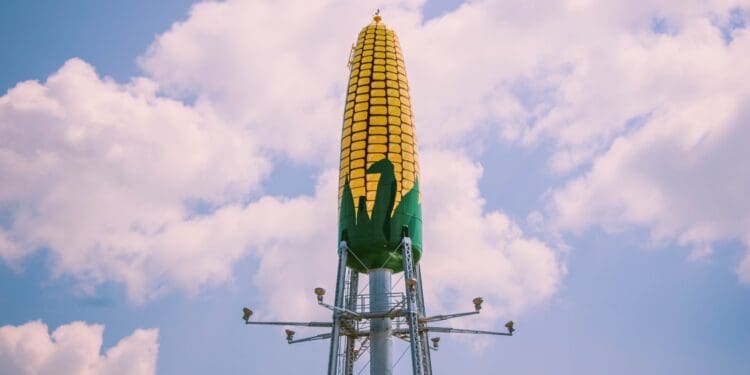 green and yellow tower under white clouds and blue sky during daytime