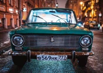 green Tofas Murat parked on roadside during nighttime