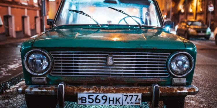 green Tofas Murat parked on roadside during nighttime