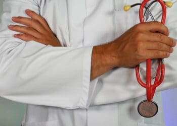 doctor holding red stethoscope