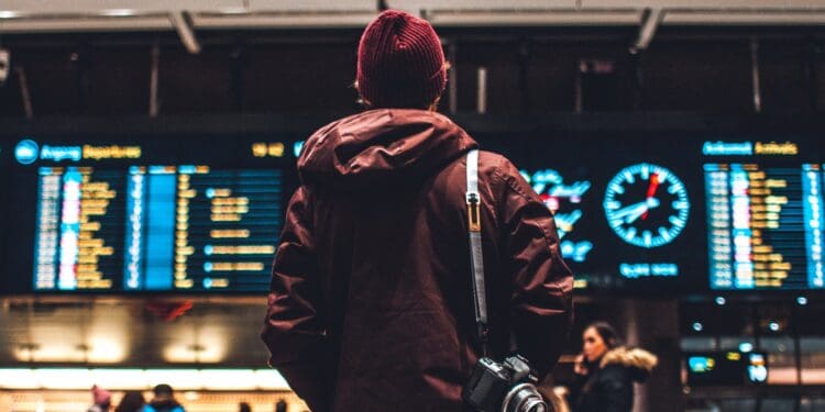 person looking up to the flight schedules
