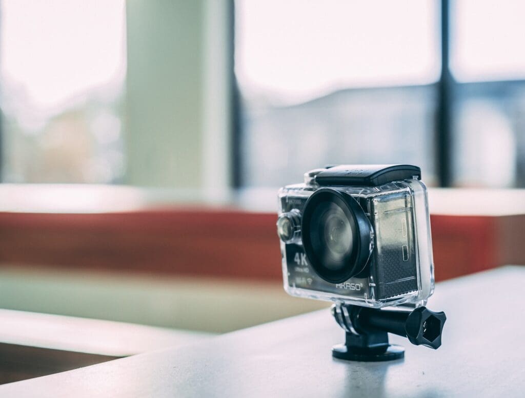 black 4K action camera with waterproof case