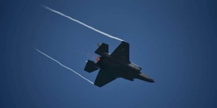 black jet plane in mid air under blue sky during daytime