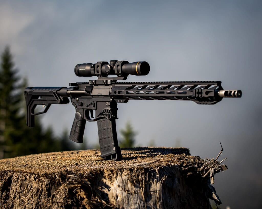 black airsoft rifle on brown grass field