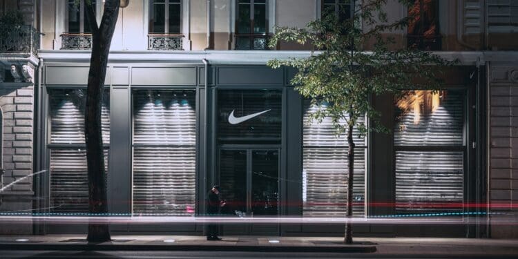 man in black standing front of clear glass door panel with gray wooden frame