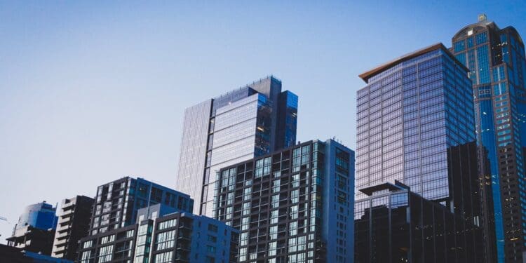 white and blue glass walled high rise building