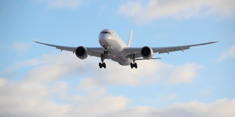white passenger plane in mid air during daytime