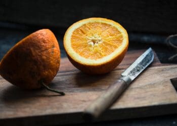 shallow focus photography of sliced lemon beside knife
