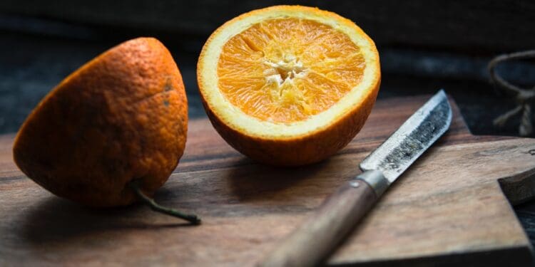 shallow focus photography of sliced lemon beside knife