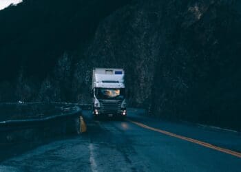 trailer truck passing on road near rail guard