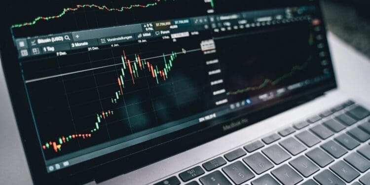 Black and Silver Laptop with Stock Market Display on Screen