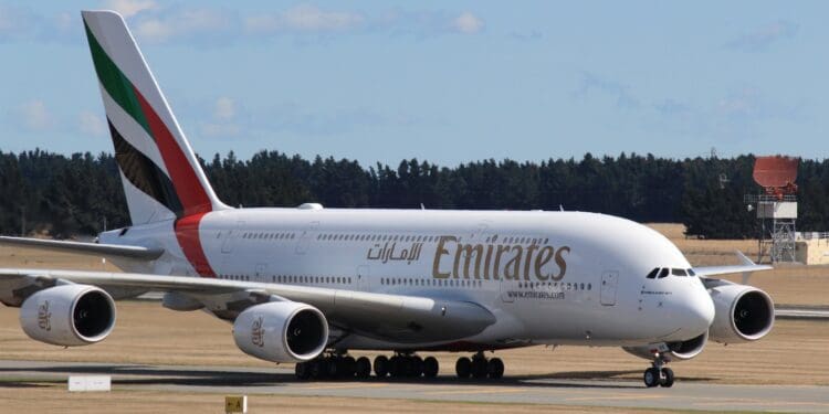 white and red passenger plane on airport during daytime