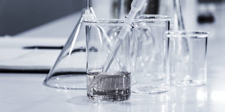 three clear beakers placed on tabletop