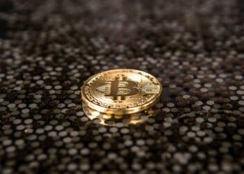 gold-colored Bitcoin coin on ground