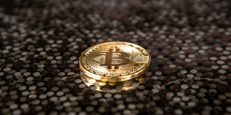 gold-colored Bitcoin coin on ground