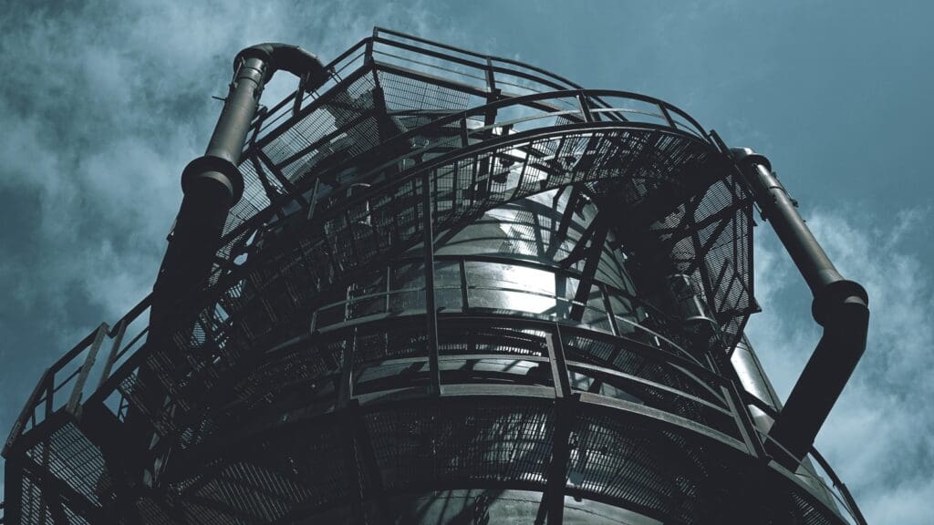 black metal spiral staircase under blue sky during daytime