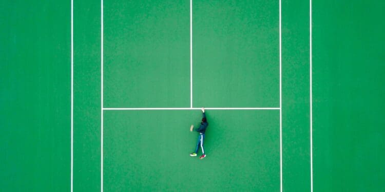 aerial photography of person lying on tennis court