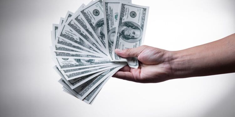 person holding 100 US Dollar banknote