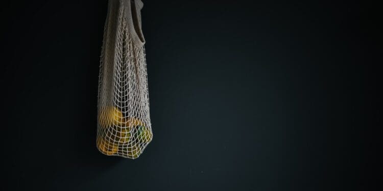 white basket with round yellow fruits inside of it