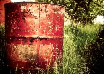 brown metal barrel on grass field