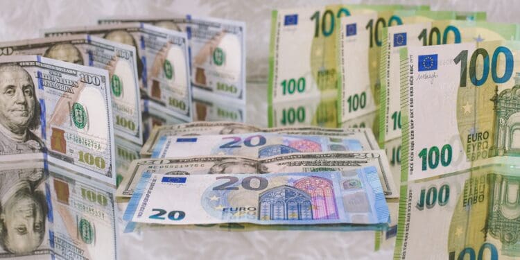 100, 20 Euro (EUR), and 100, 20 Dollar (USD) banknotes placed back-to-back vertically and horizontally on a reflecting surface.