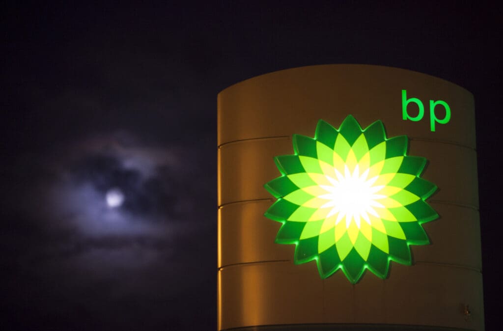 Clouds partially cover the moon beyond an illuminated BP logo as it sits on a sign outside a gas station operated by BP Plc in Guildford, U.K., on Monday, Dec. 8, 2014. Brent crude oil for January settlement climbed 67 cents to $66.86 a barrel on the London-based ICE Futures Europe exchange at 12:08 p.m. local time. after having slid $2.88 to $66.19 yesterday, the lowest close since September 2009. Photographer: Jason Alden/Bloomberg