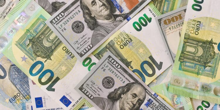 A pile of 20, 100 Euro (EUR), and 20, 100 Dollar (USD) banknotes.