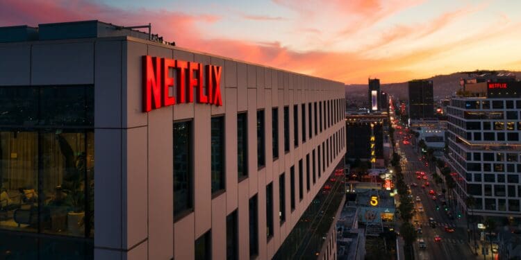 Netflix sign on a building at sunset.