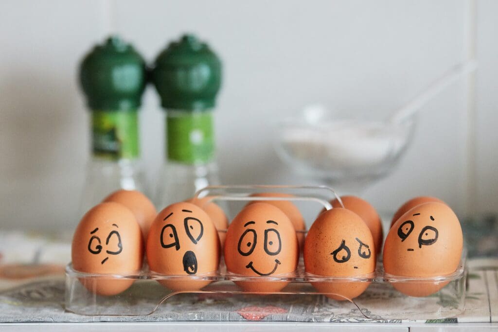 Painted eggs expressing a range of emotions from joy to depression.