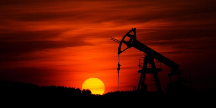Pump-jack mining crude oil with the sunset