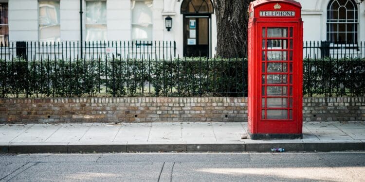 red telephone booth beside road