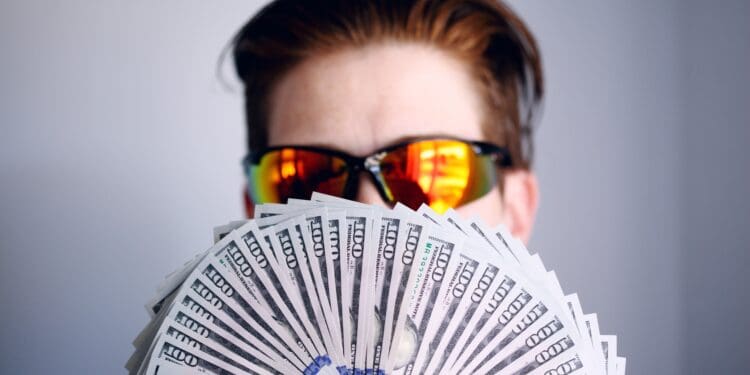 Shane with a fan of American one hundred dollar bills.