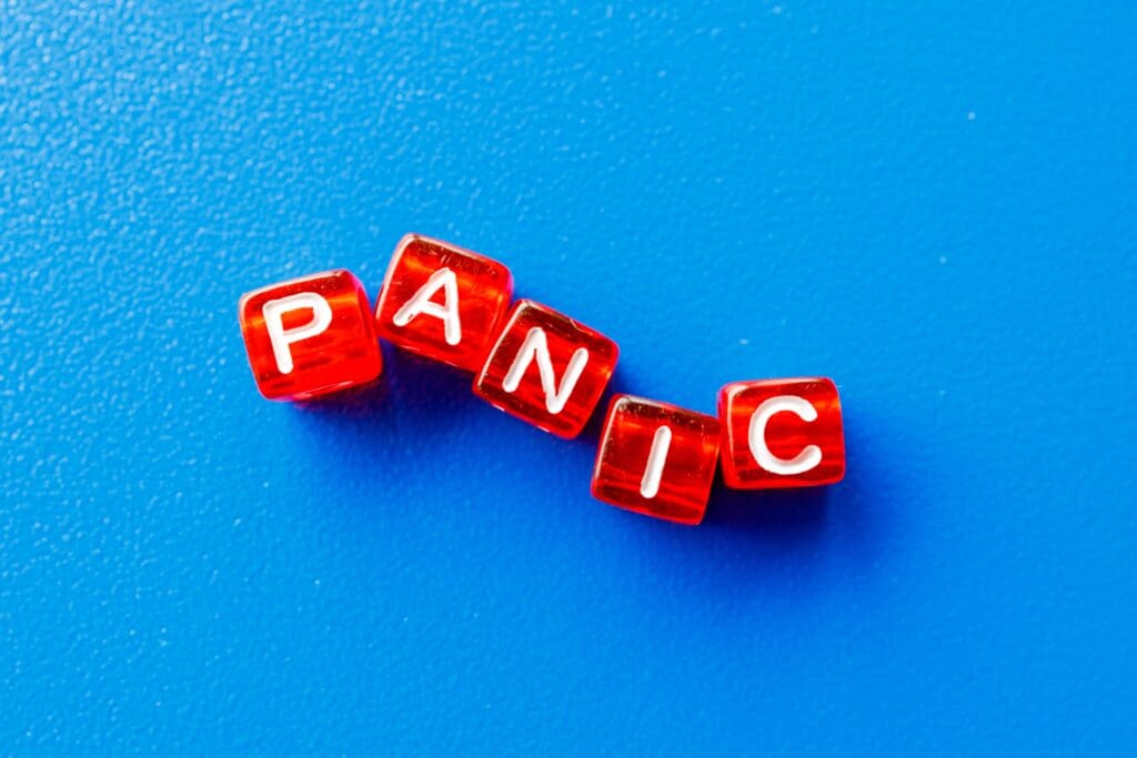 the word panic is laid out from red cubes on a blue background