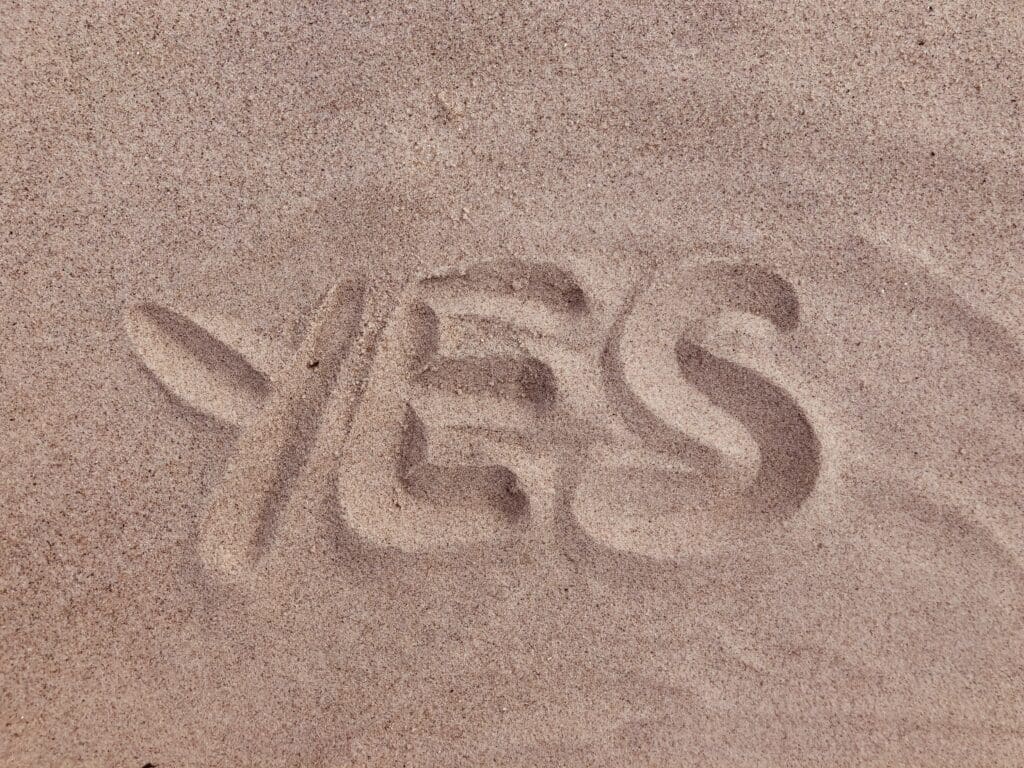 yes text on brown sand