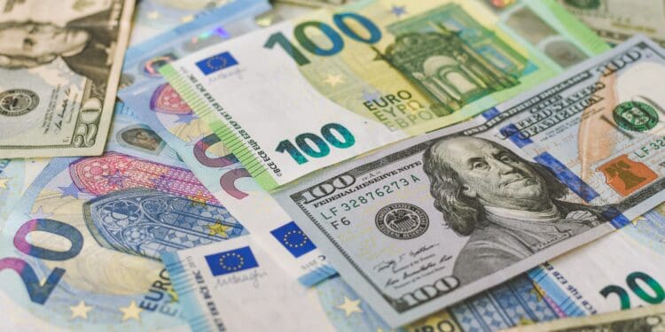 100 Euro (EUR), and 100 Dollar (USD) banknotes placed horizontally around other variety of banknotes.