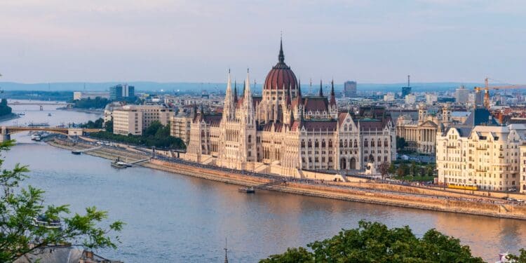 brown concrete building near body of water during daytime