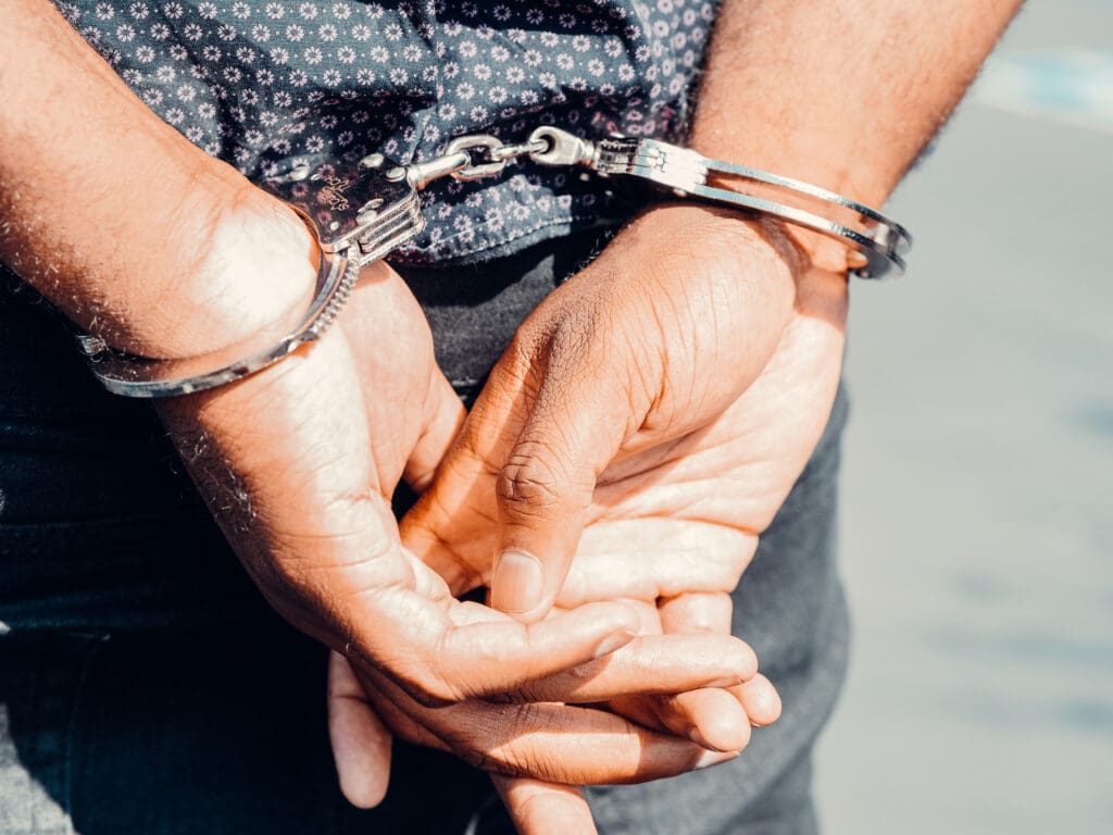 Close up photography of person in handcuffs