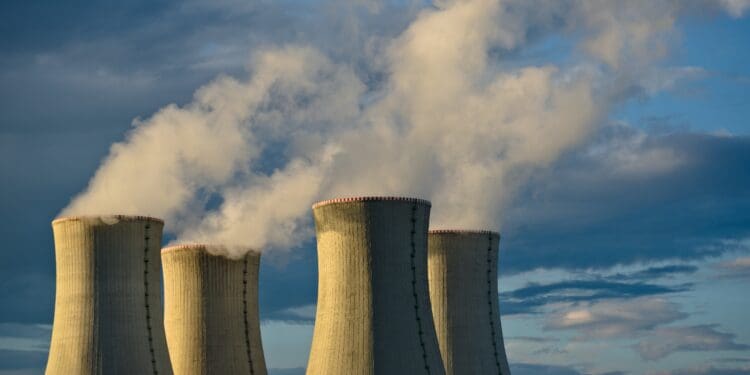 gray concrete towers under white clouds and blue sky during daytime