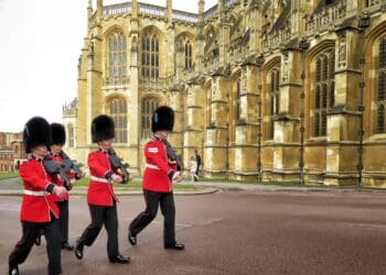 Red Uniformed guardsmen march before the Queen of England arrives to Sunday Easter Service at Windsor Palace in London, United Kingdom