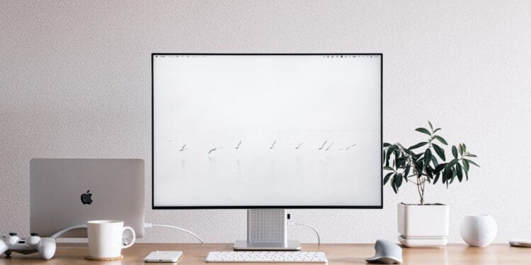 silver imac on brown wooden desk